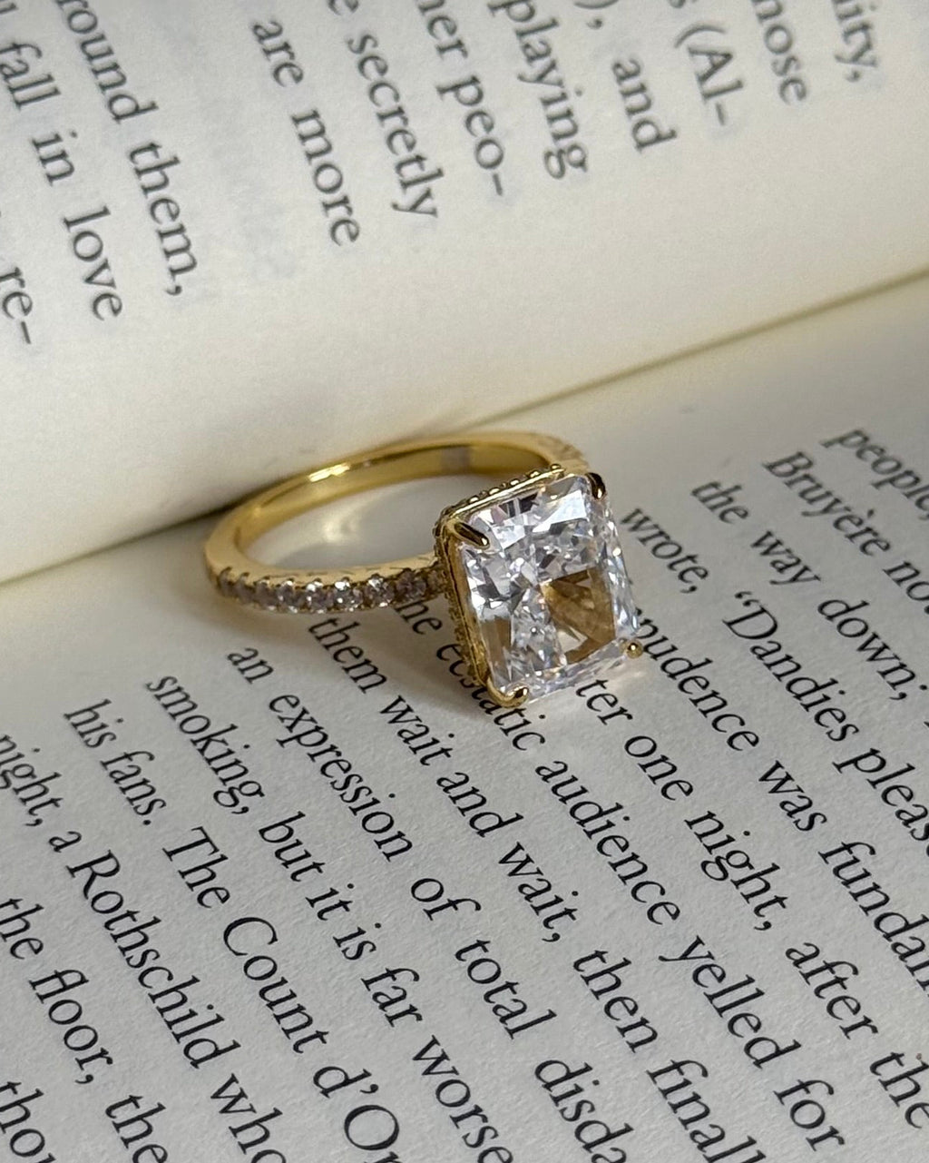 Gold ring with a diamond on an open book