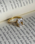 Gold ring with a diamond on an open book