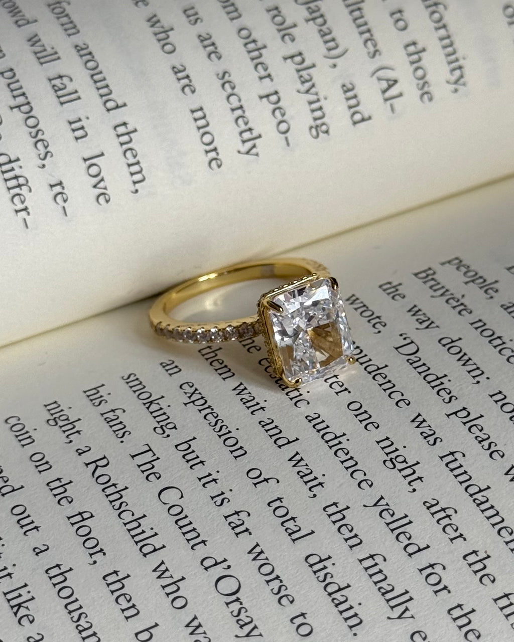 Gold ring with a diamond on an open book