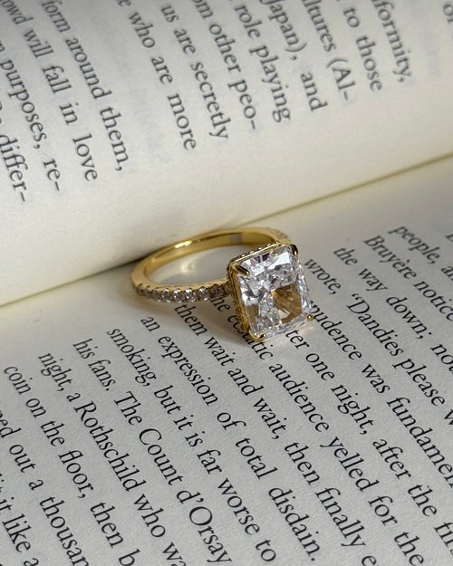 Gold ring with a diamond on an open book