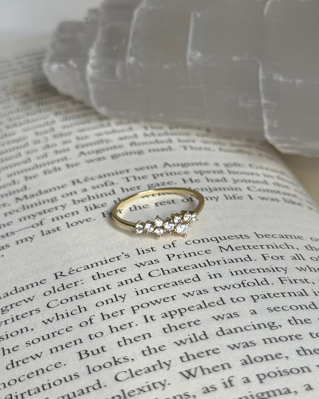 Gold ring with diamonds on an open book