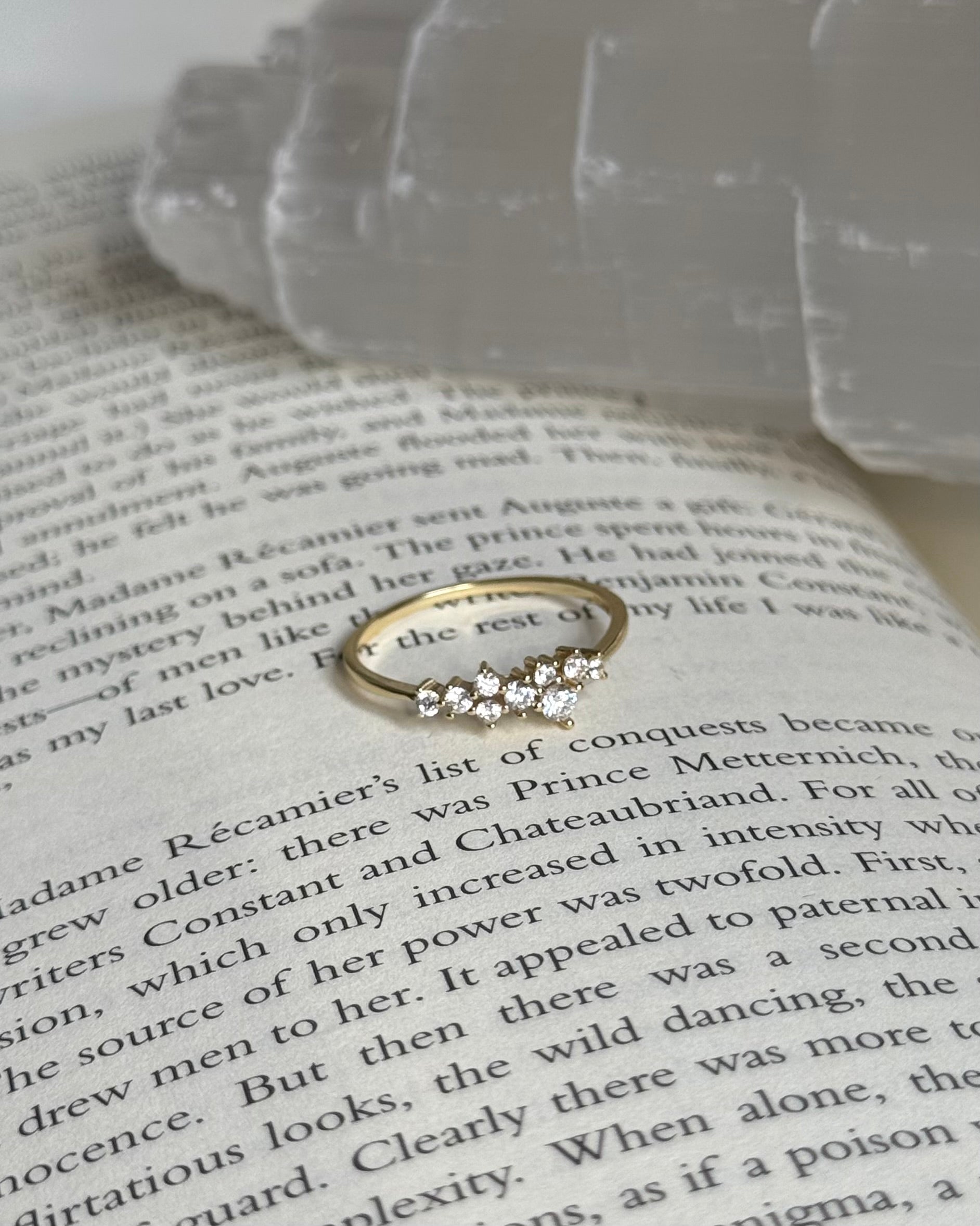 Gold ring with diamonds on an open book